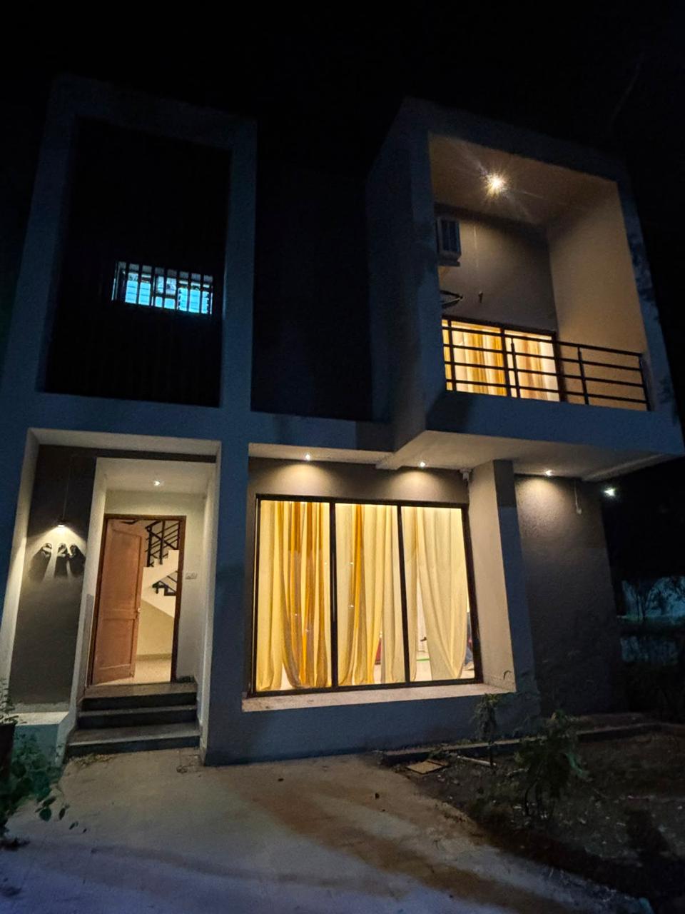 Homestay entrance and facade lit up in the evening