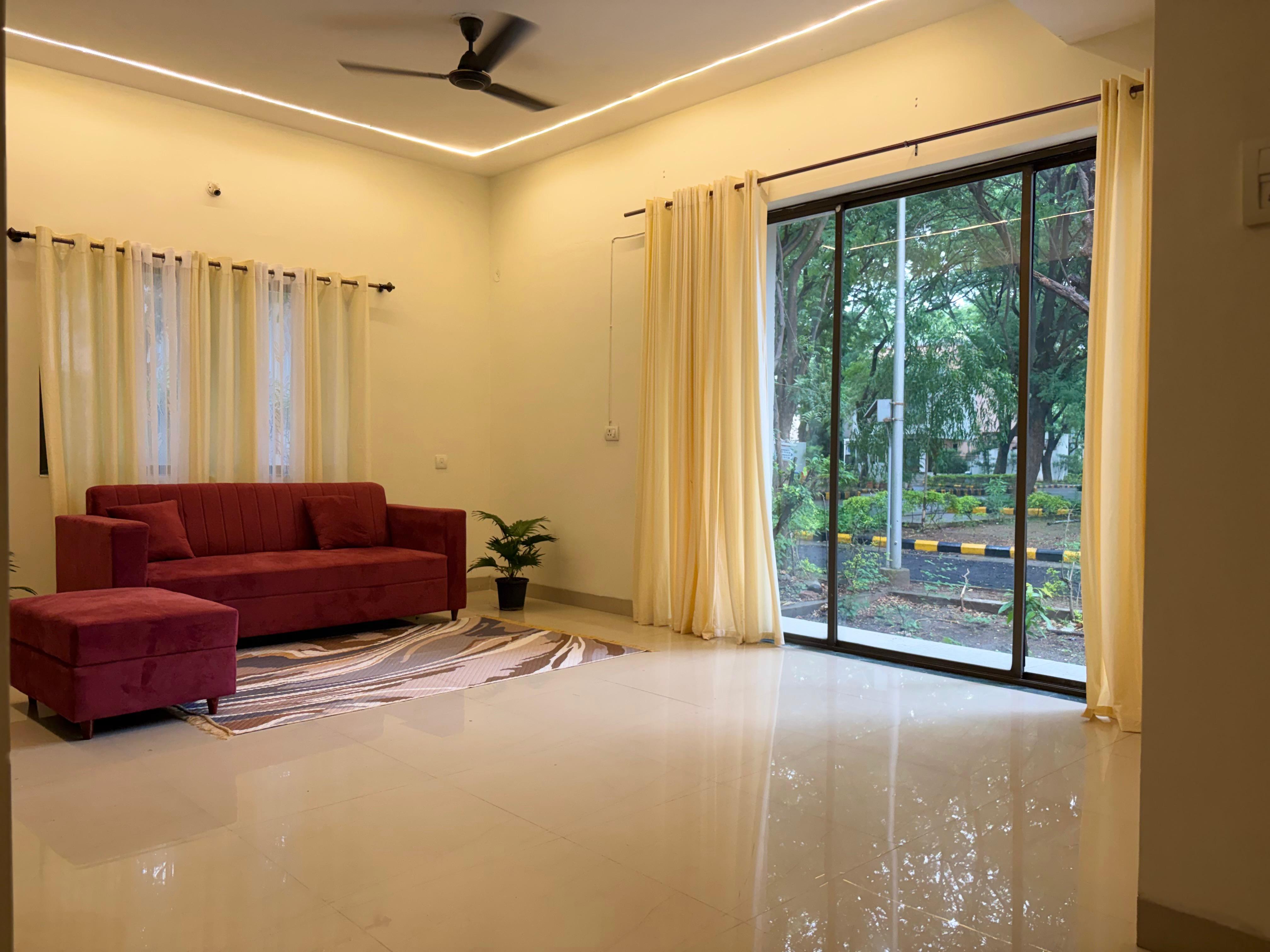Living room with sofa and garden view through sliding doors