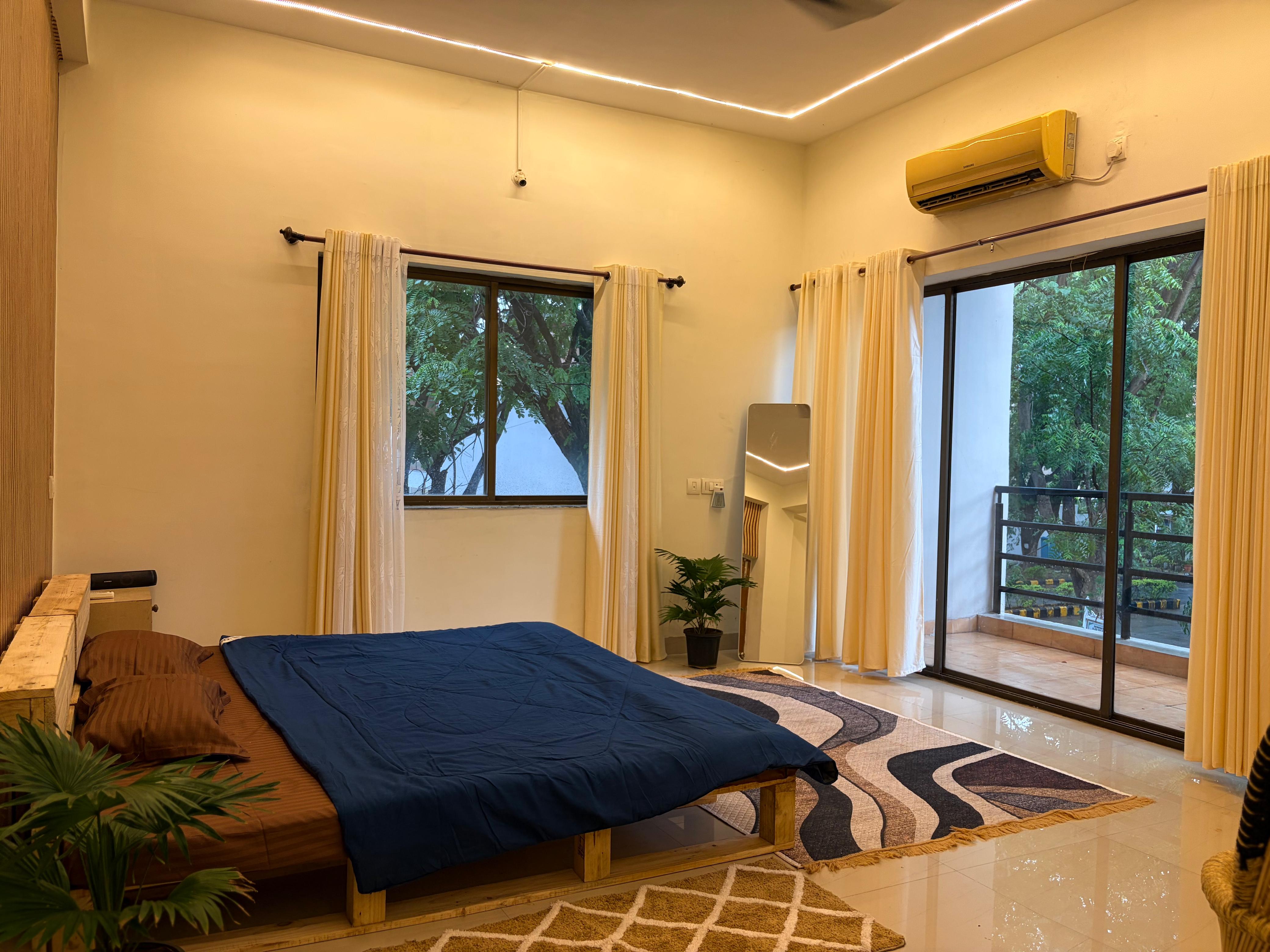 Bedroom with navy bedspread, alternate angle
