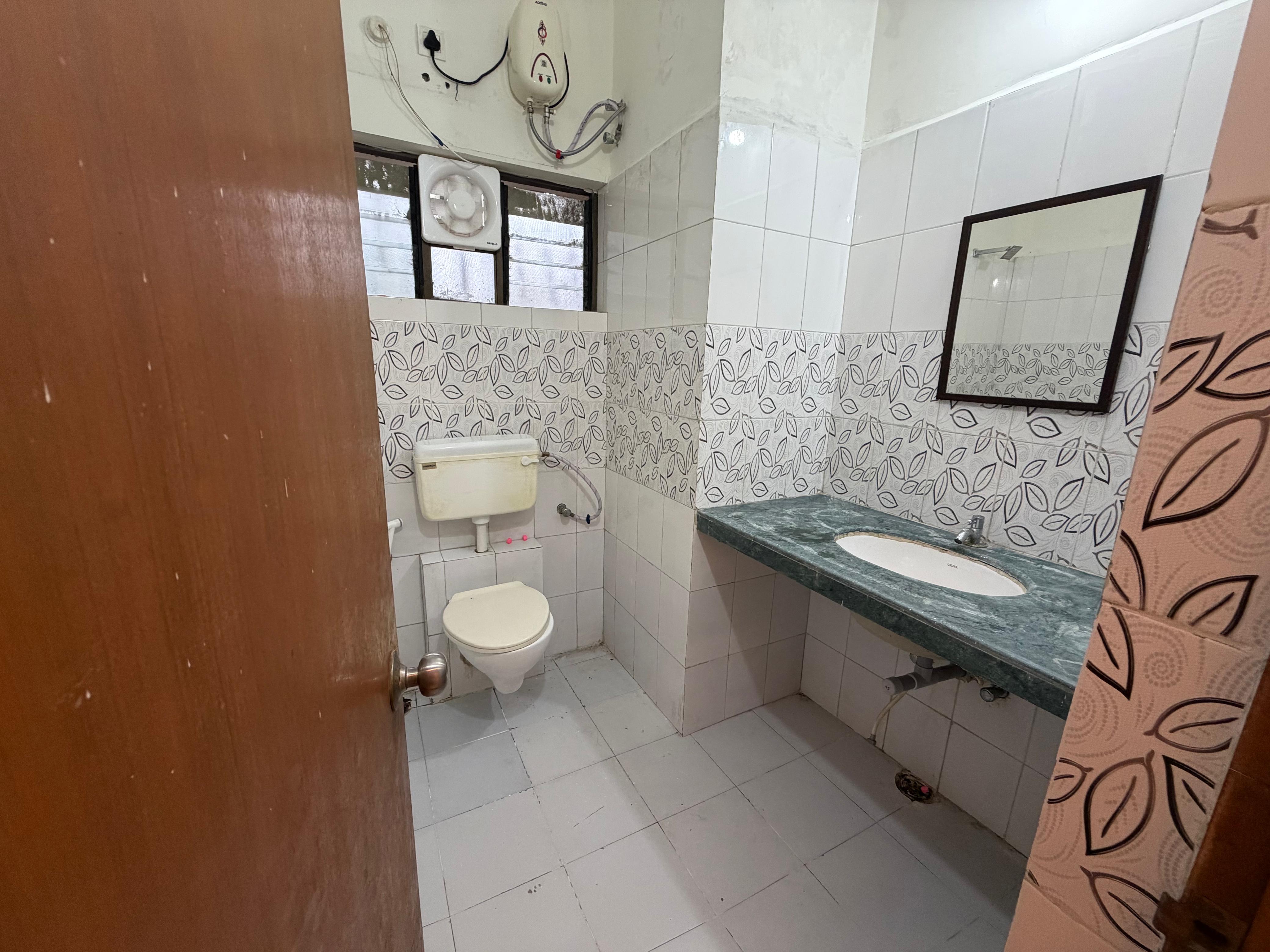 Attached bathroom with sink and mirror
