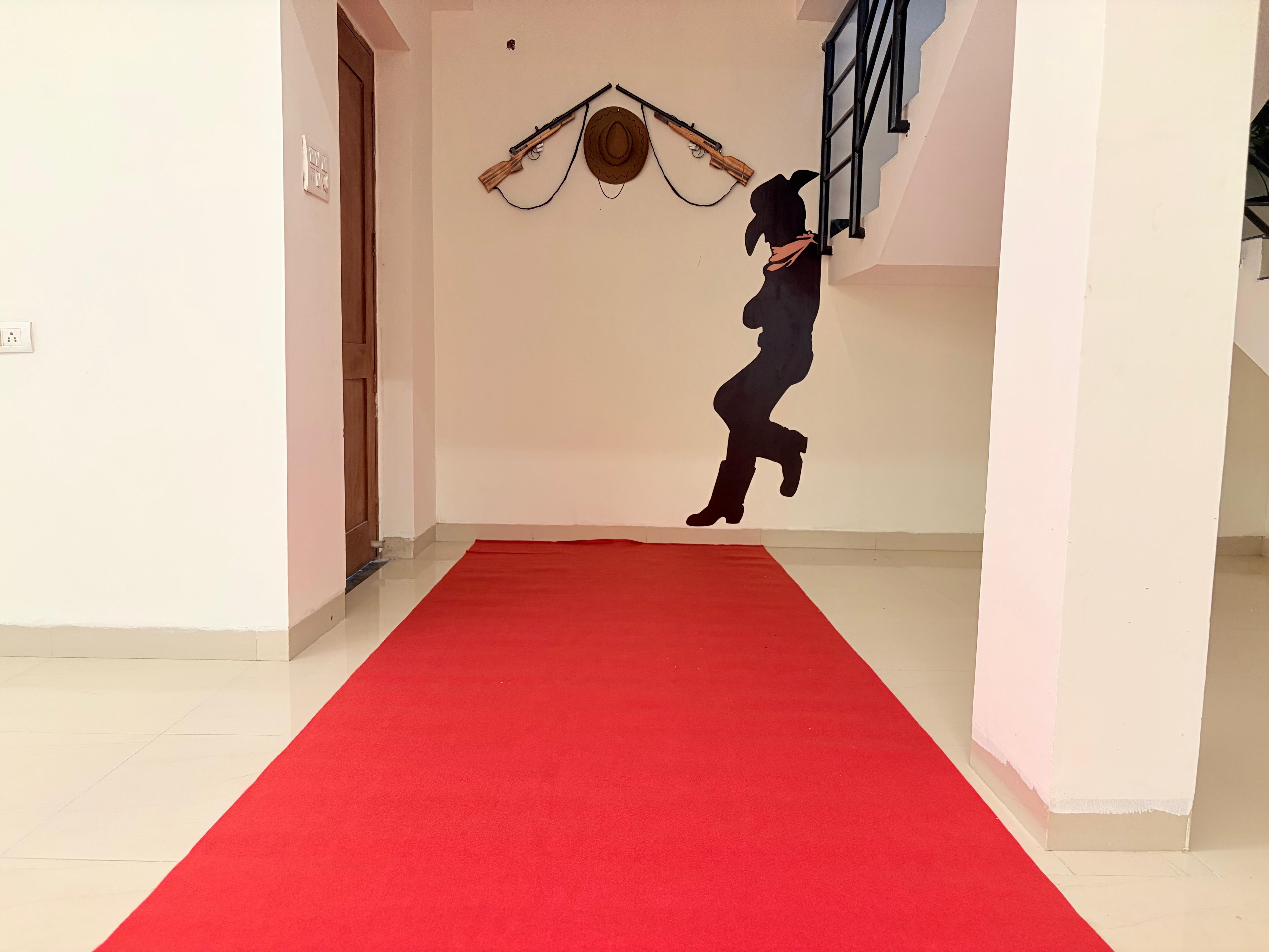 Hallway with decorative wall art and red carpet runner