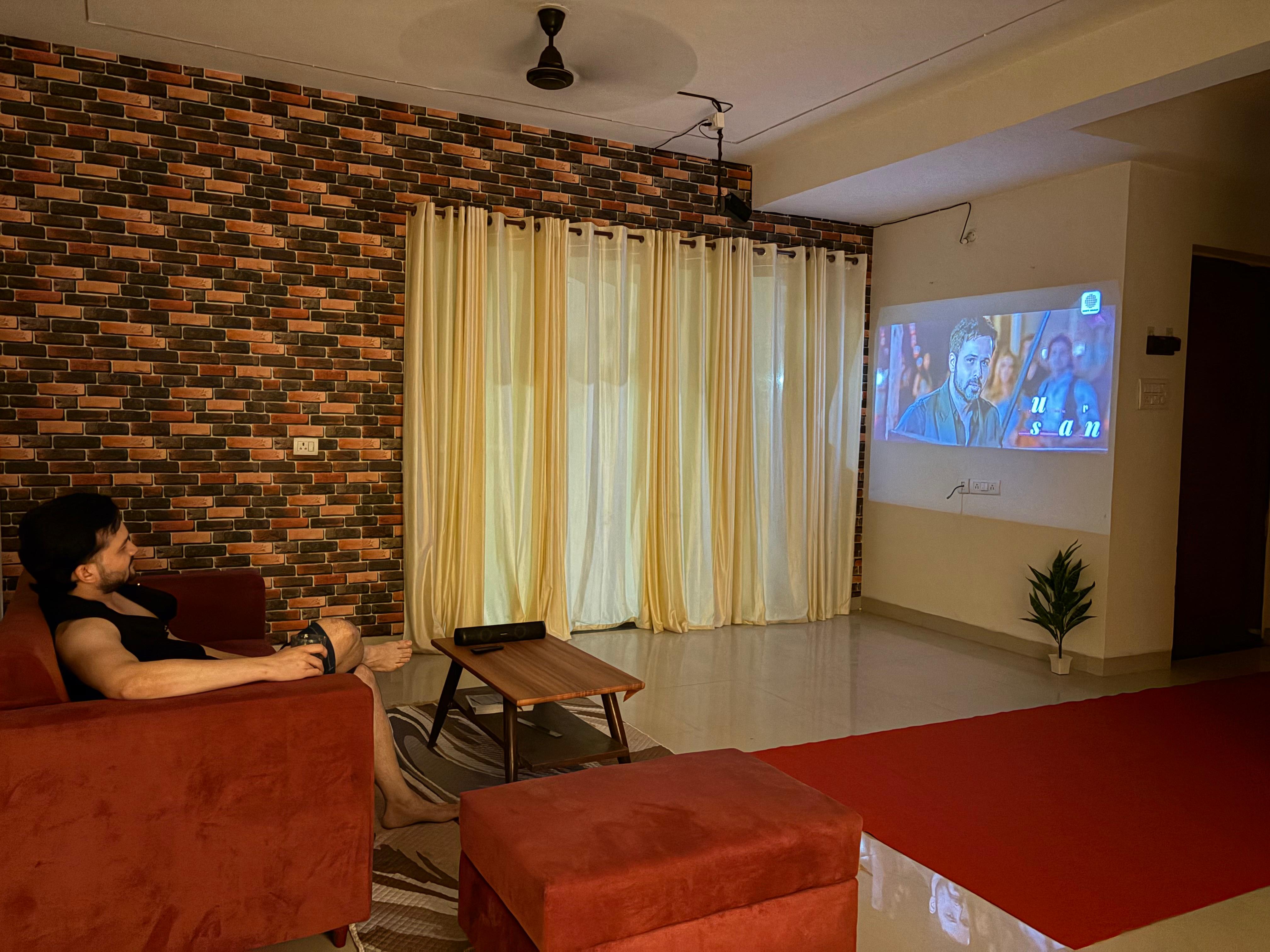 Living room with maroon sofa and patterned rug
